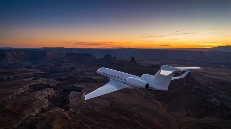 Private jet on a solo repositioning ferry flight above clouds at dusk, cinematic aerial aviation photography