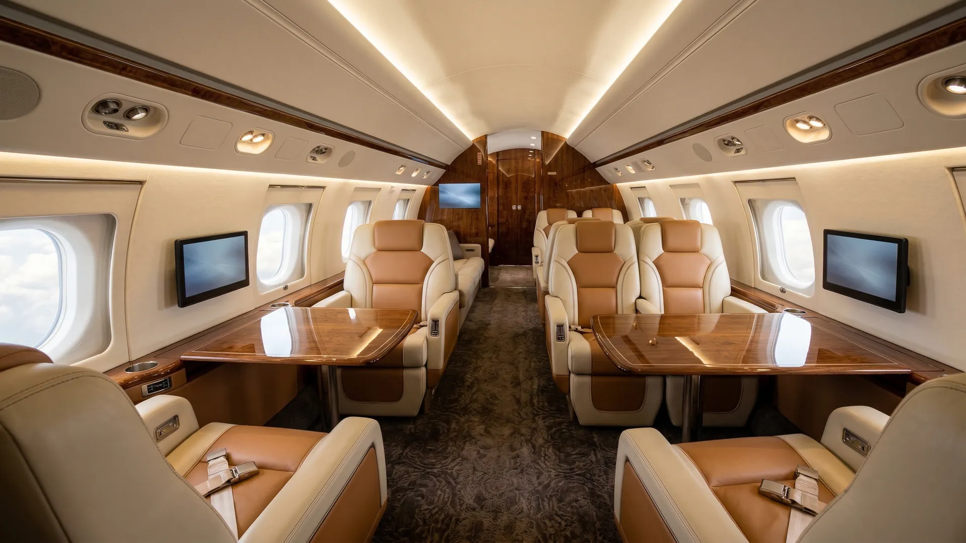 Luxury private jet cabin interior with cream leather seating and warm ambient lighting representing the NetJets jet card experience