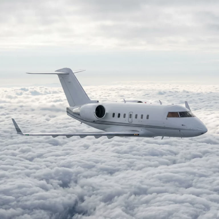 Bombardier Challenger 604 private jet flying above clouds in level cruise flight