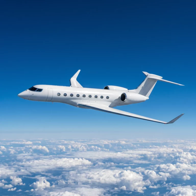 Gulfstream G700 private jet cruising above clouds in clear blue sky, showing full aircraft profile