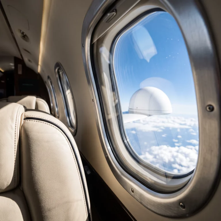 Private jet cabin interior with sunlight through windows, representing in-flight connectivity technology
