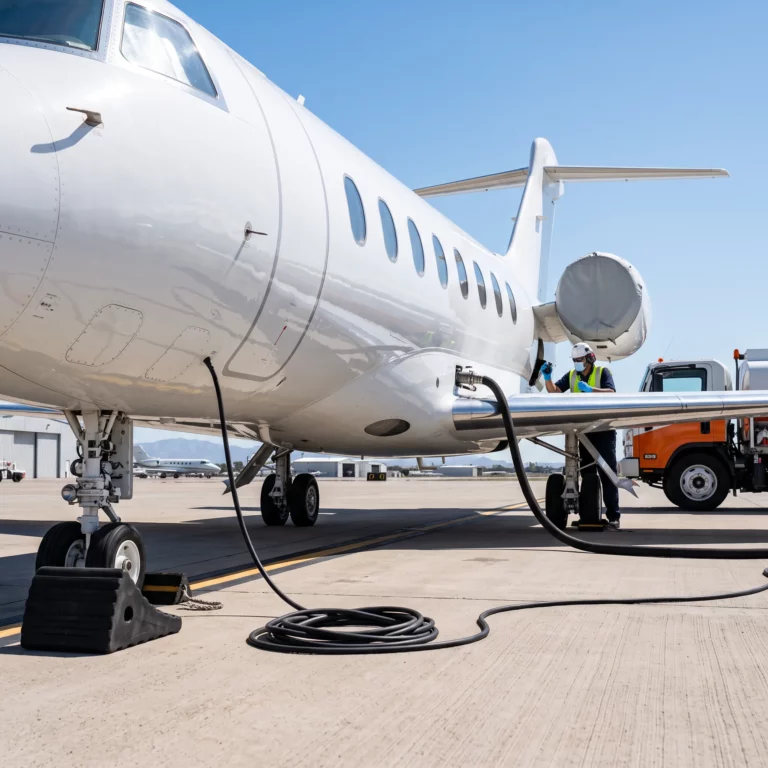 Private jet being refueled on an FBO ramp in bright daylight