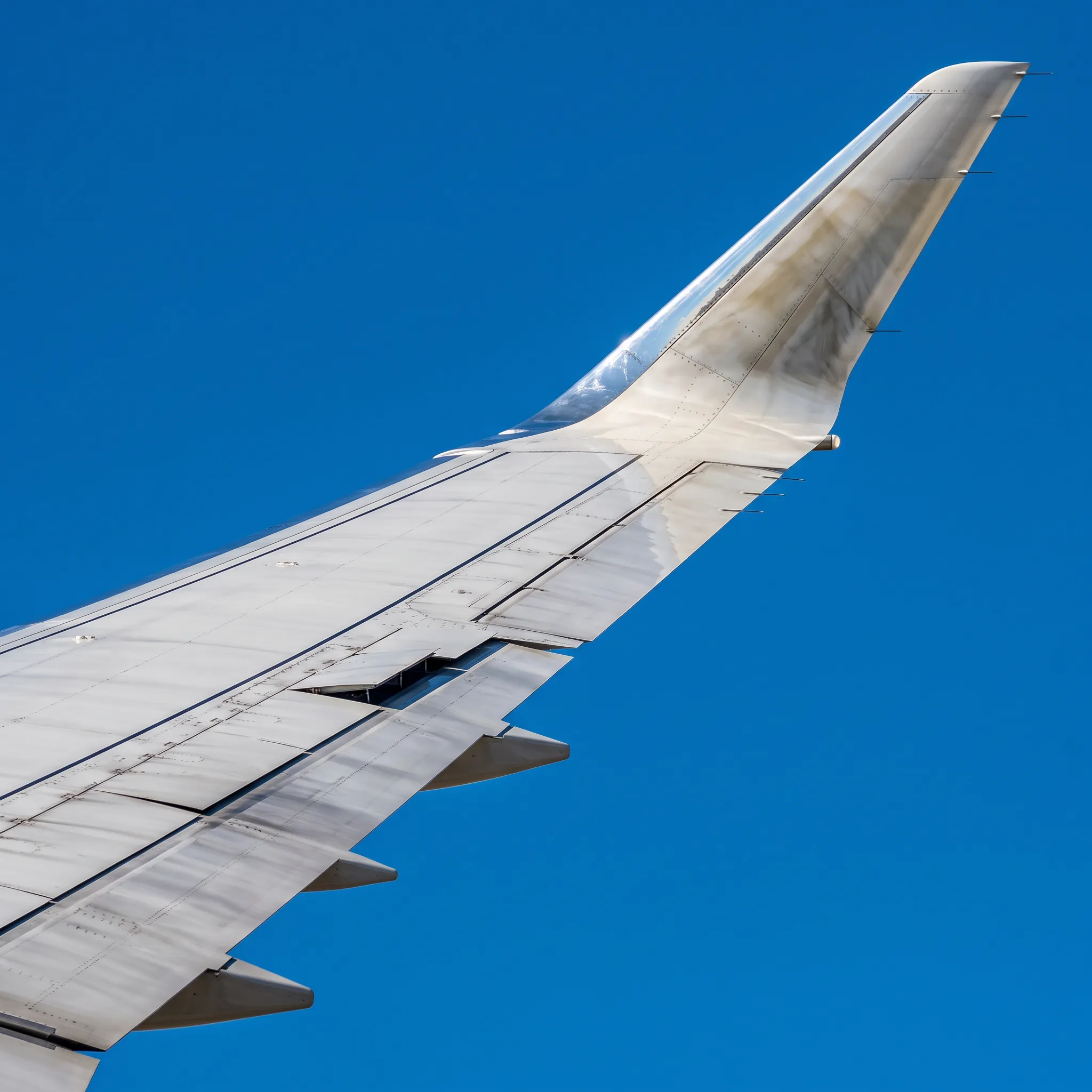 Close-up of Bombardier Global 8000 wing and winglet during steep descent
